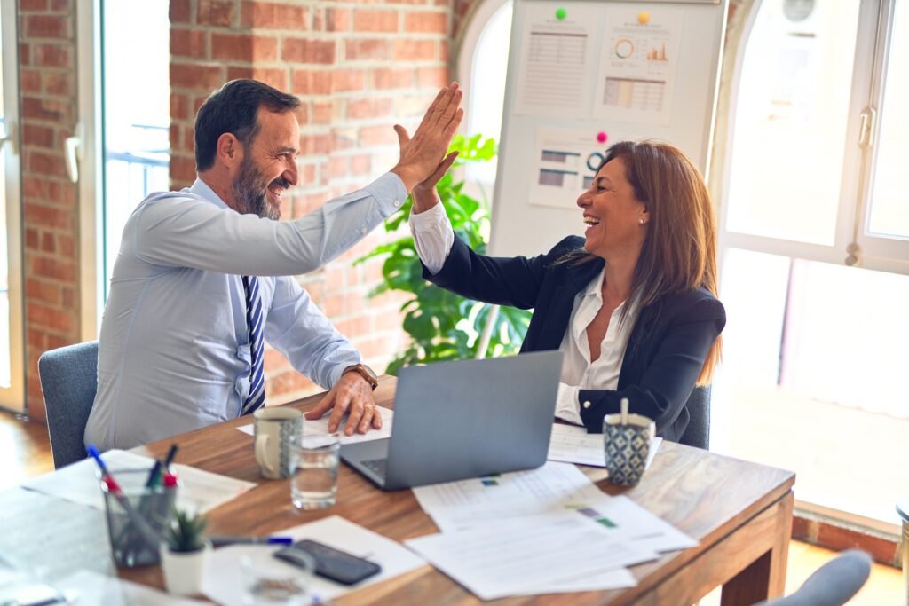 business man and woman high fiving